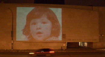 Image of a childs face projected onto the wall of The Winnipeg Art Gallery